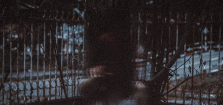 anonymous mysterious ghost woman standing in dark forest at night